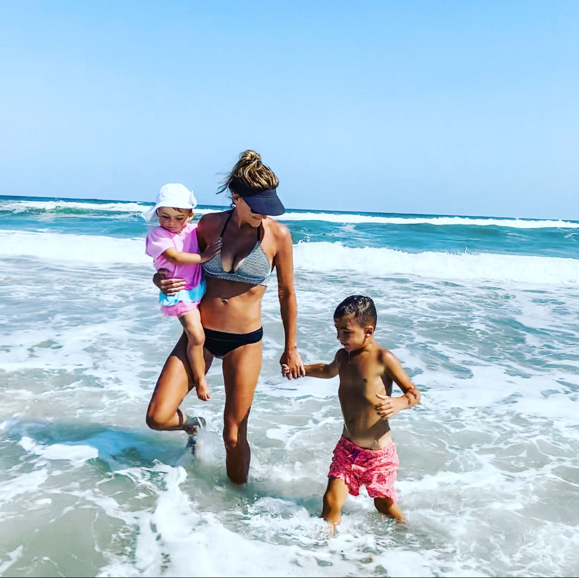Dr. Kimberly running on the beach with her children, demonstrating active motherhood and fitness