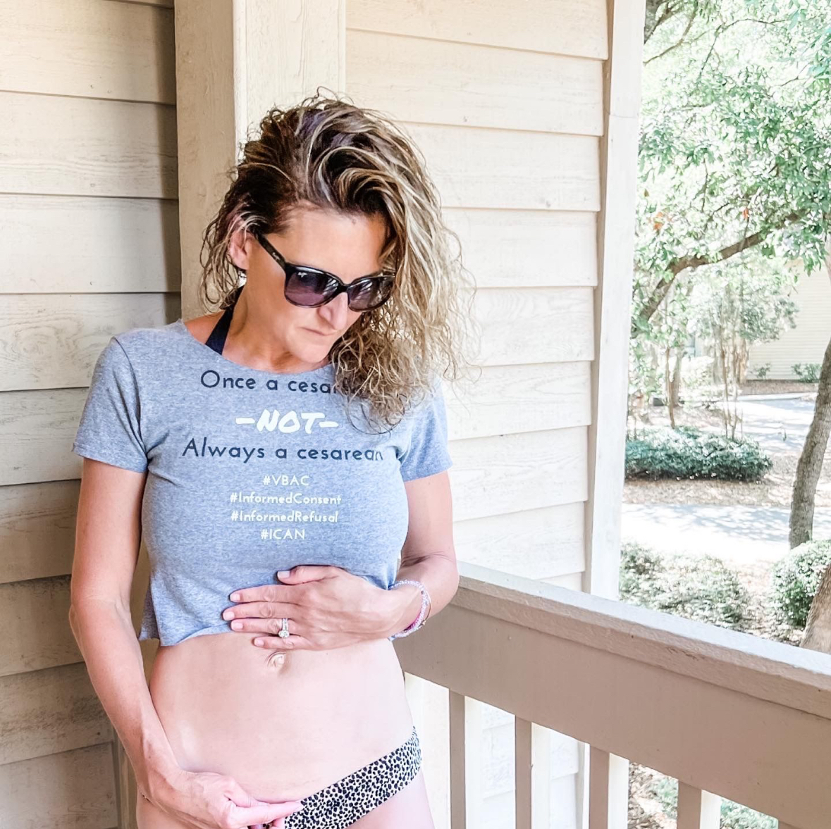 Dr. Kimberly during pregnancy wearing a shirt advocating for VBAC (Vaginal Birth After Cesarean)